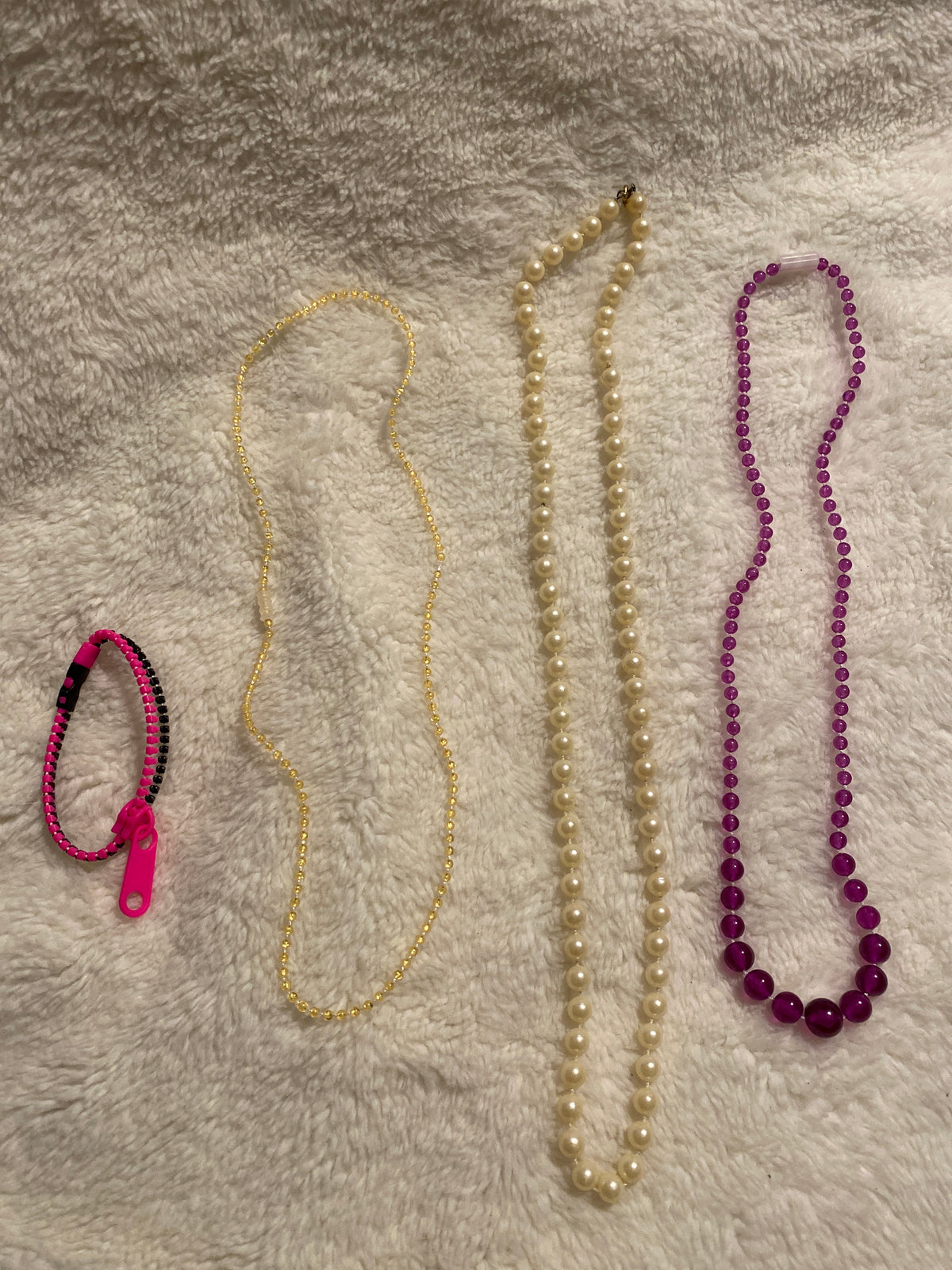3 play necklaces and a Cool zipper wrist band