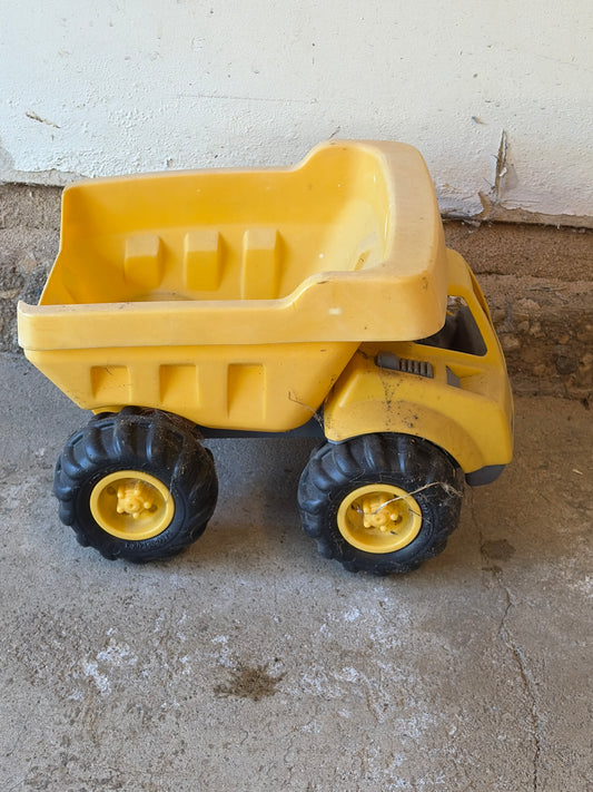 Yellow dump truck Sun bleached