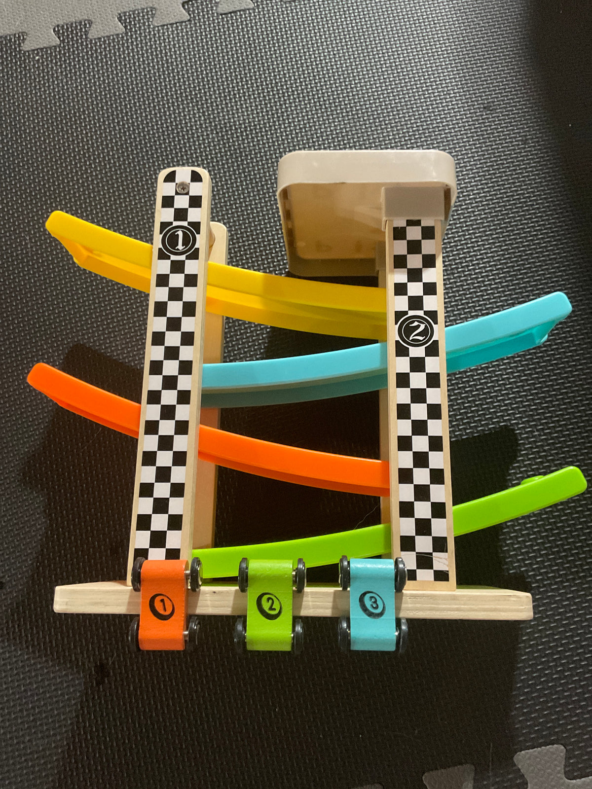 Wooden car racetrack with 3 cars