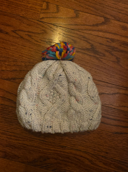 White knit knit with rainbow pomp pom. Est tw