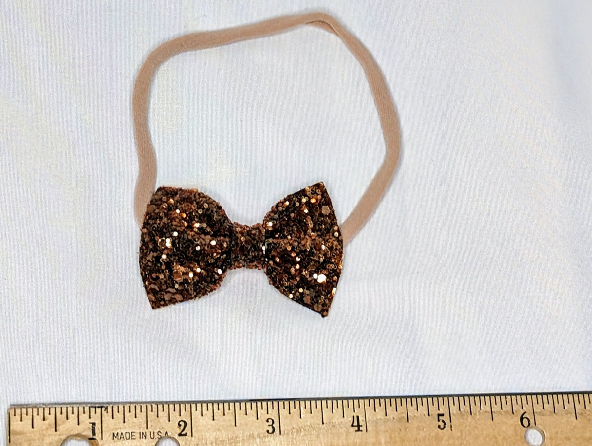 EUC dark orange glitter bow on nylon headband