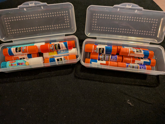 Two small pencil boxes & Glue sticks galore!